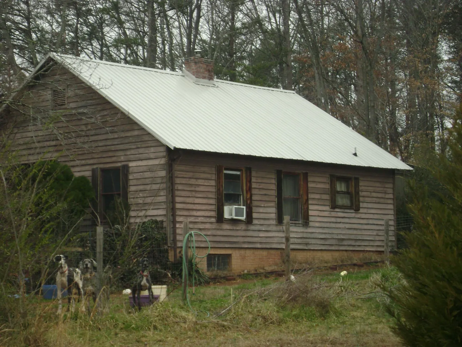 White metal roof on an old wood sided farmhouse, from a Metal Roof Installation job in Hudson